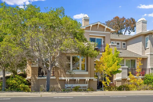 a front view of a residential houses with yard