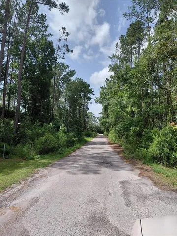 a view of a street with a trees in the background
