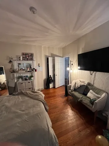 a bedroom with furniture and a flat screen tv