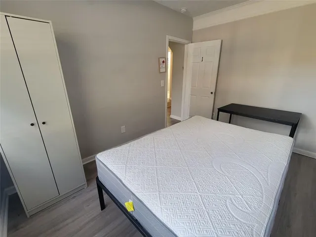 a bed room with a bed and wooden floor