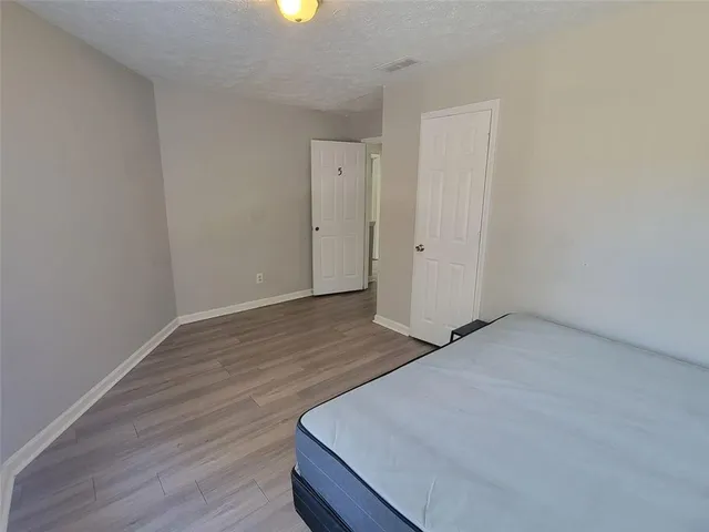 a view of a room with wooden floor