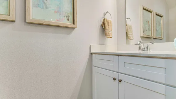 a bathroom with a sink vanity and mirror