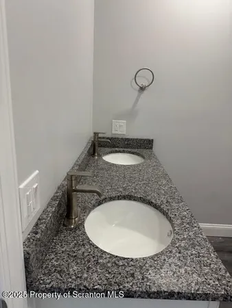 a bathroom with a granite countertop sink and mirror