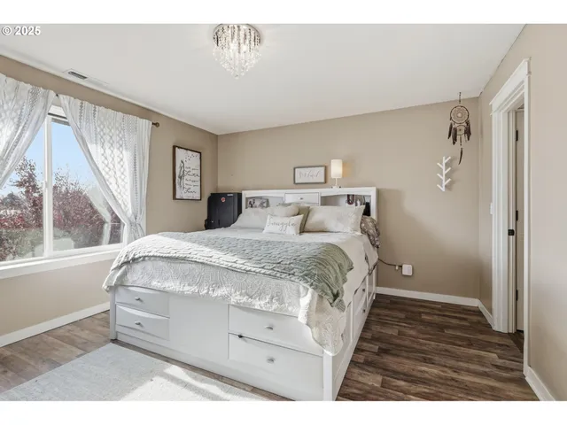 a spacious bedroom with a large bed and a window