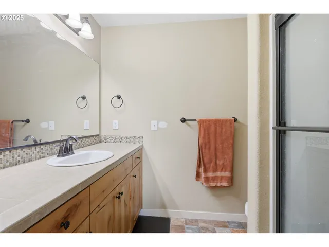 a bathroom with a sink vanity and mirror