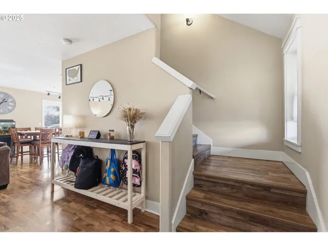 a view of entryway and hall with wooden floor