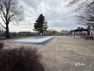 a view of backyard with white fence