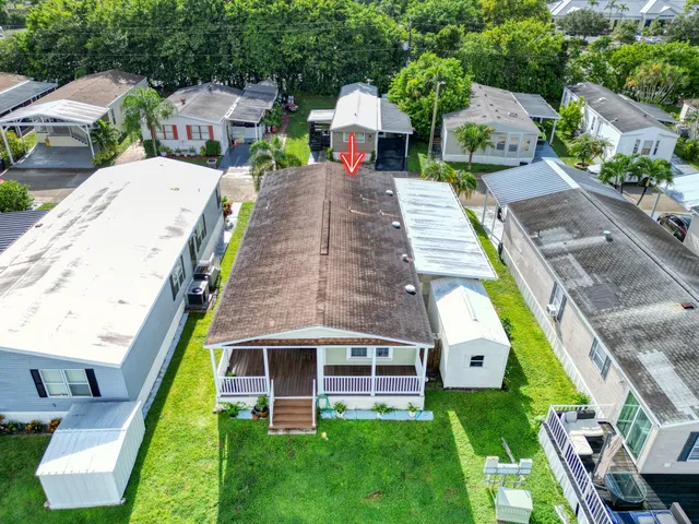 an aerial view of a house with swimming pool garden and patio