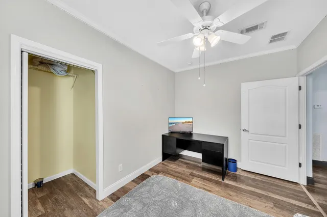 a view of a hallway with wooden floor