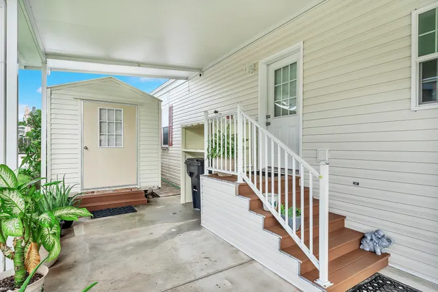 a view of a porch with wooden floor and a potted plant