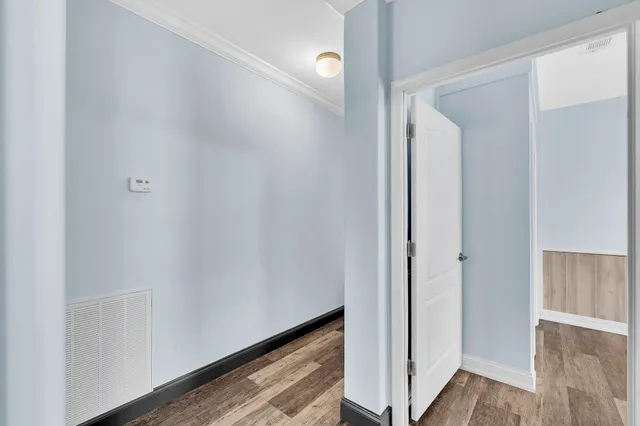 a view of a room with wooden floor and ceiling fan