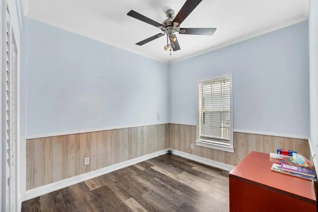 a view of a hallway with wooden floor and staircase