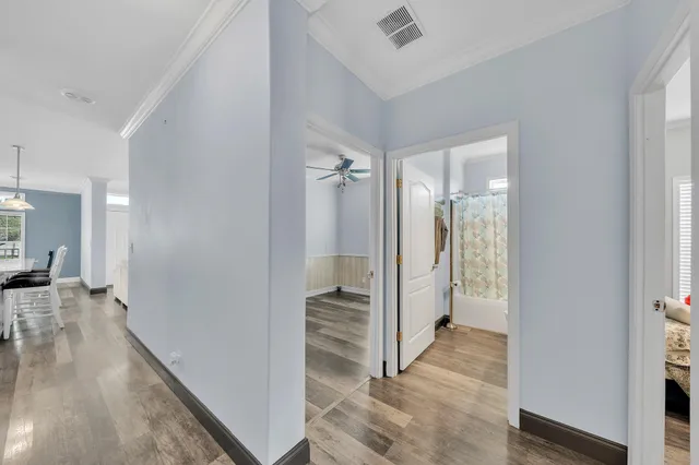 a view of a house with a yard and palm trees