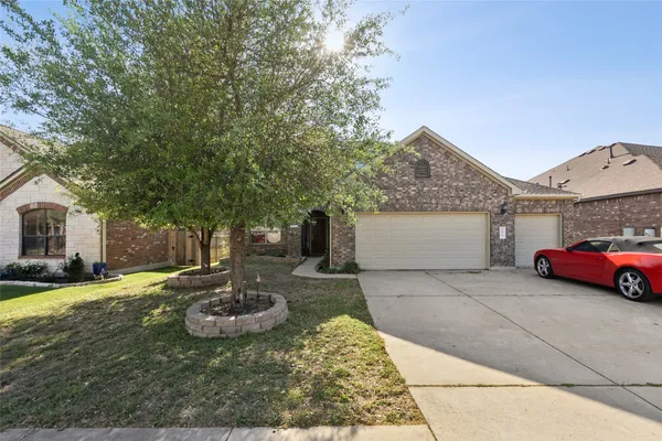 a view of a house with a yard and garage