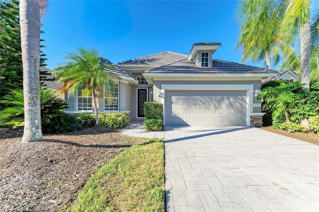 6710 Pebble Beach Way Lakewood Ranch, FL 34202 - Photo 1 of 1 a front view of a house with garden