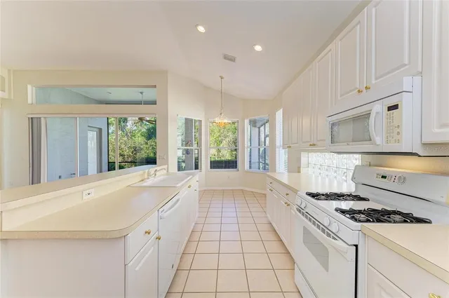 an empty room with windows and ceiling fan