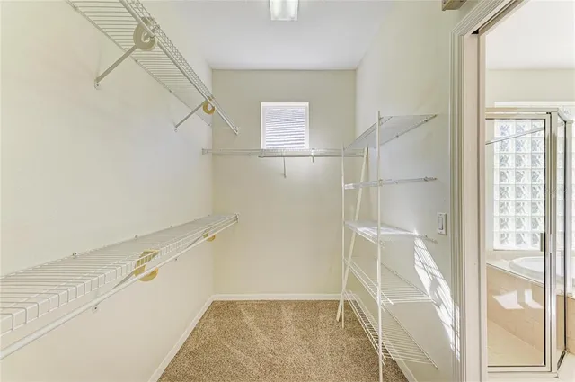 a view of a hallway with a chandelier fan and wooden floor