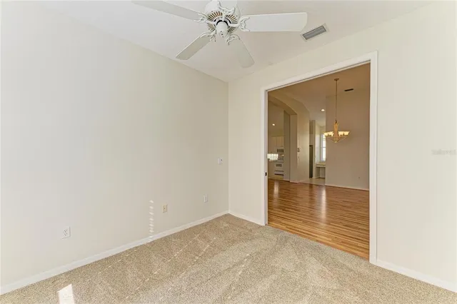 a view of a house with a yard and basketball court