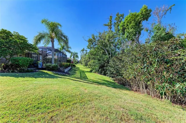 an aerial view of a house with swimming pool and porch with furniture