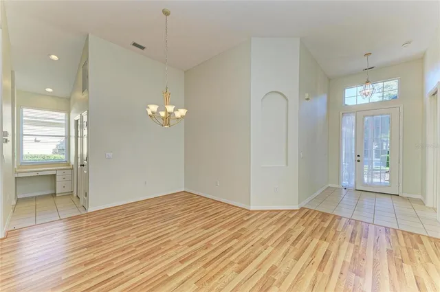 a view of room with wooden floor and ceiling fan