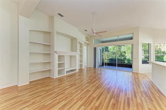 a view of wooden floor and windows in a room