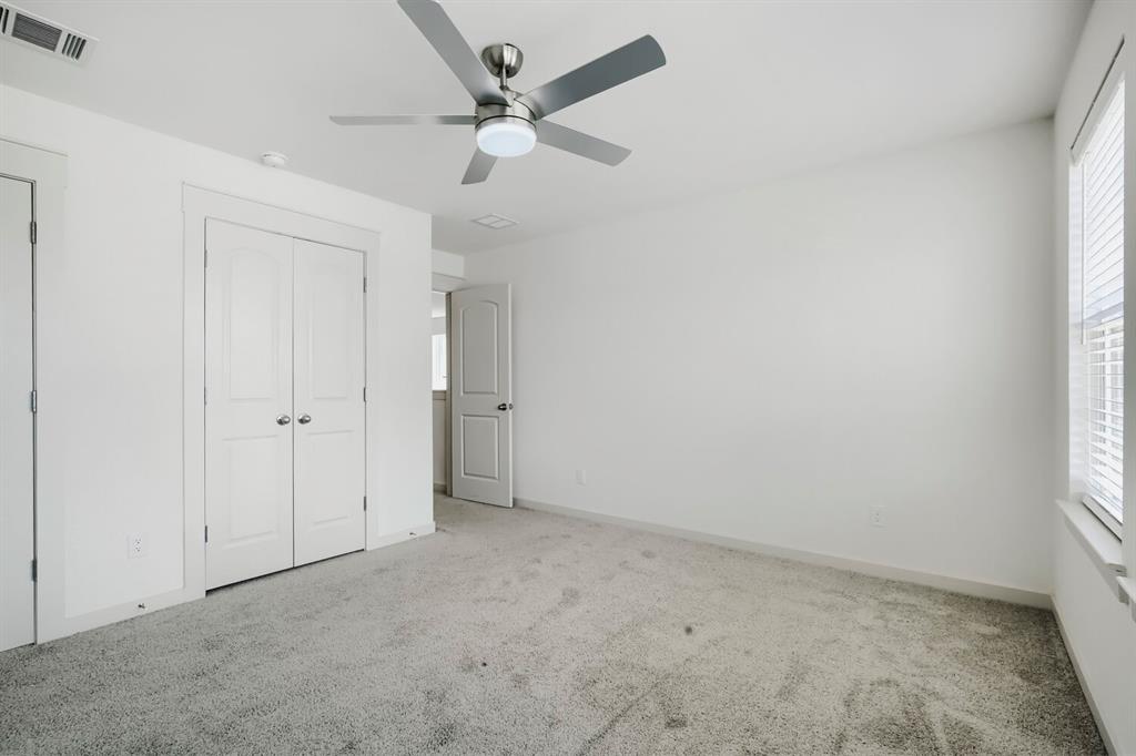 1368 Cedar Street Forney, TX 75126 - Photo 20 of 29 Neutral color palette, grey carpet, ceiling fan with integrated lighting, white interior doors, and window with blinds