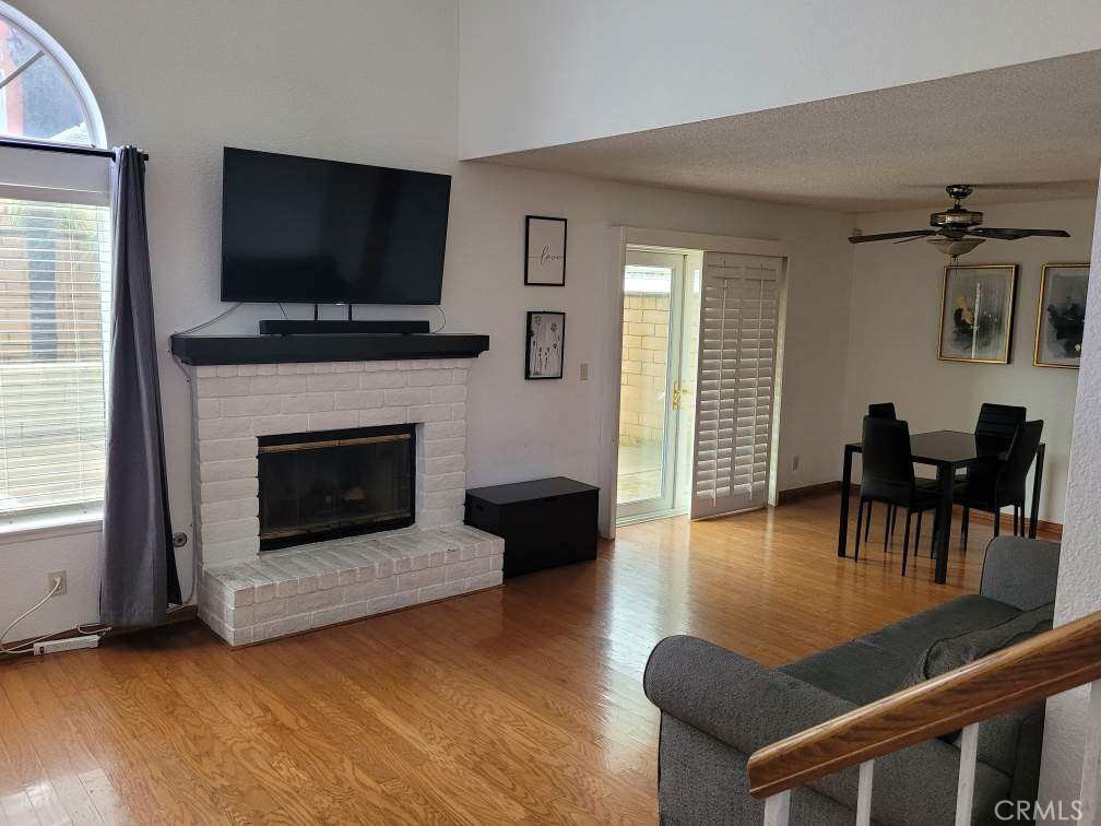 7449 Langham Place Rancho Cucamonga, CA 91730 - Photo 2 of 6 a living room with furniture a fireplace and a flat screen tv
