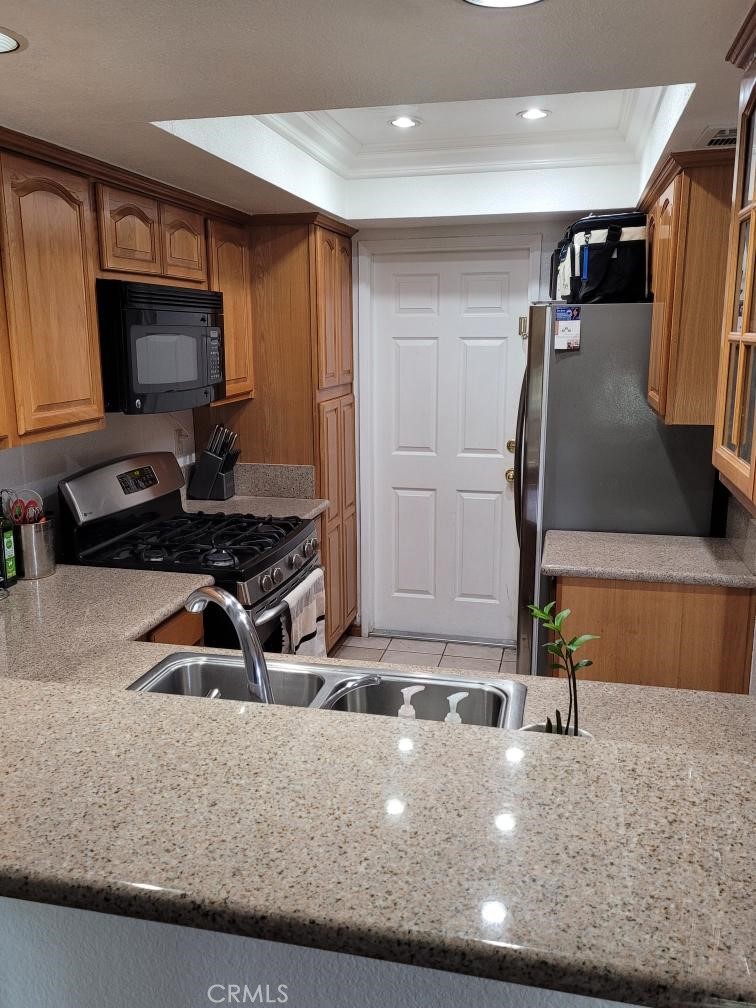 7449 Langham Place Rancho Cucamonga, CA 91730 - Photo 3 of 6 a kitchen with sink a faucet and a counter top space
