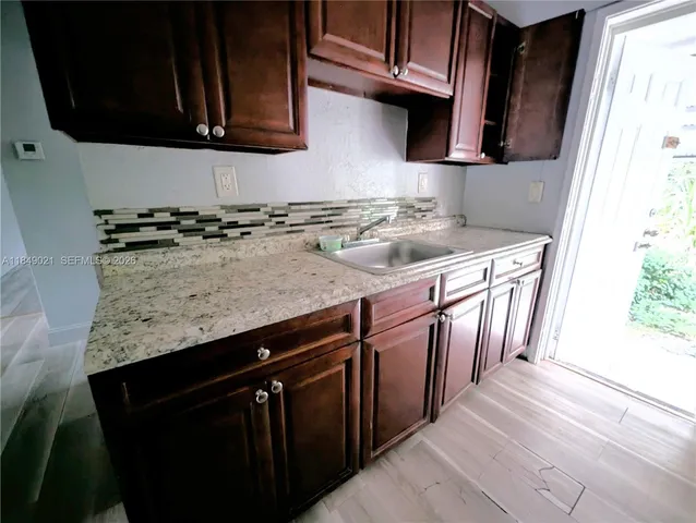 a kitchen with stainless steel appliances granite countertop a sink stove and cabinets