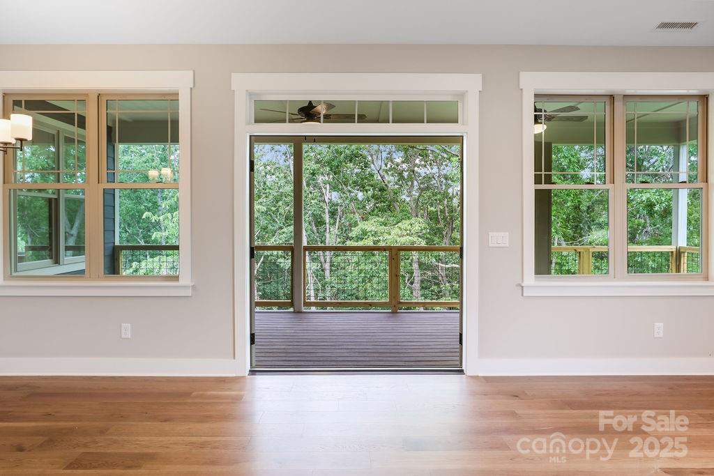 21 Craftsman Overlook Ridge Arden, NC 28704 - Photo 16 of 36 a view of an empty room with wooden floor and a window