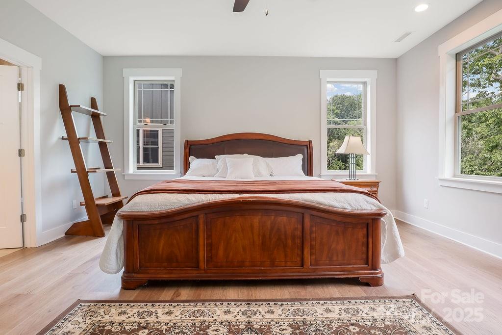 21 Craftsman Overlook Ridge Arden, NC 28704 - Photo 19 of 36 a bedroom with a large bed and a window