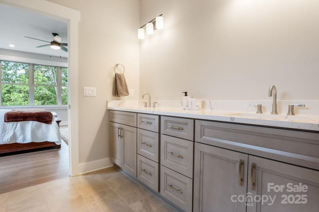 21 Craftsman Overlook Ridge Arden, NC 28704 - Photo 21 of 36 a en suite bathroom with a double vanity sink and a window
