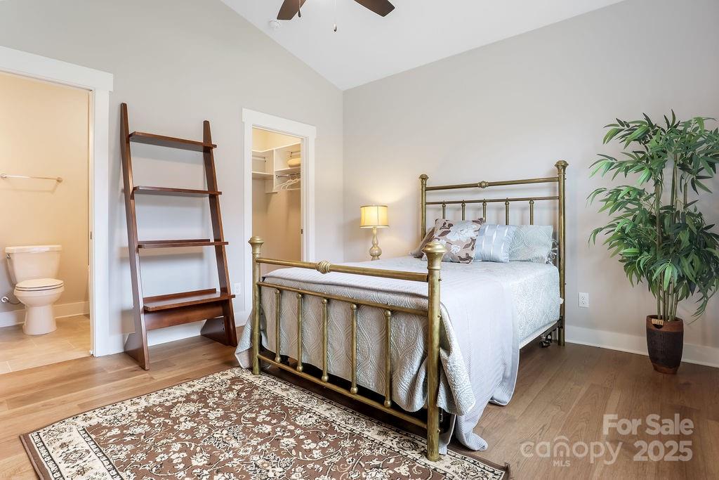 21 Craftsman Overlook Ridge Arden, NC 28704 - Photo 26 of 36 a spacious bedroom with a bed and a potted plant