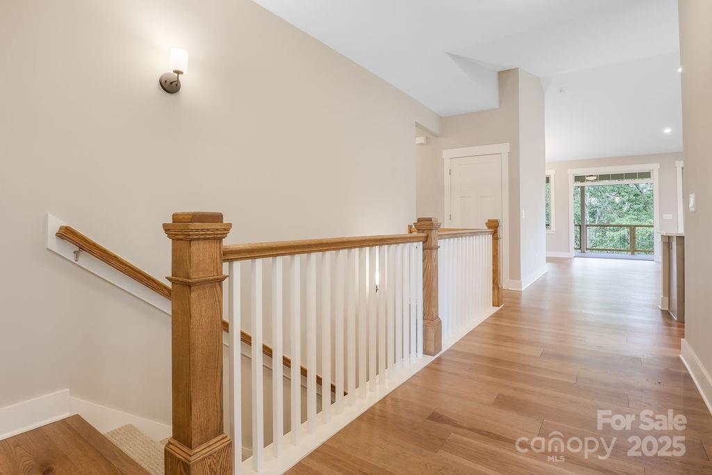 21 Craftsman Overlook Ridge Arden, NC 28704 - Photo 29 of 36 a view of a hallway with wooden floor and stairs