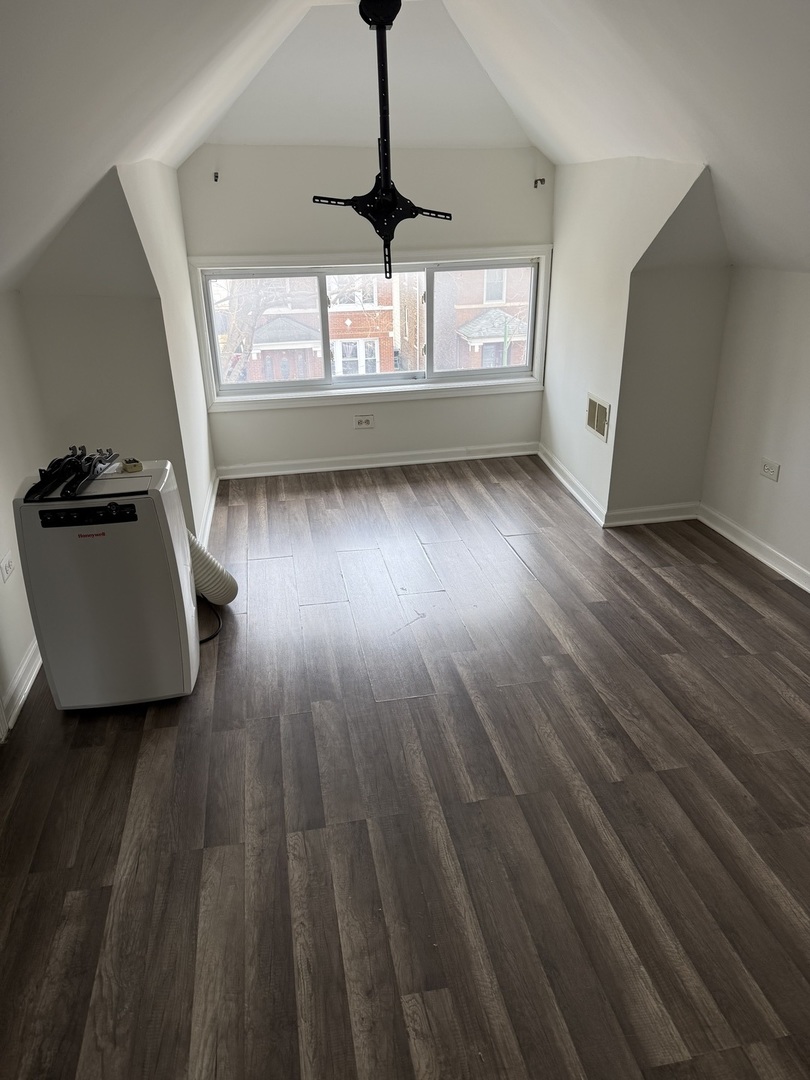 4612 South Spaulding Avenue, Unit 3 Chicago, IL 60632 - Photo 2 of 6 a living room with wooden floor and windows