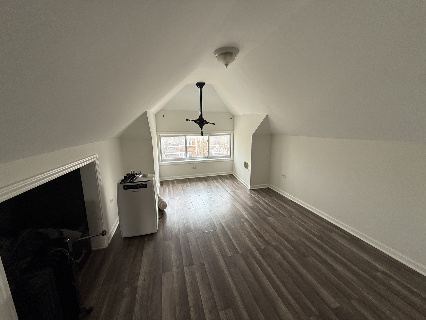 4612 South Spaulding Avenue, Unit 3 Chicago, IL 60632 - Photo 3 of 6 wooden floor in an empty room with a window