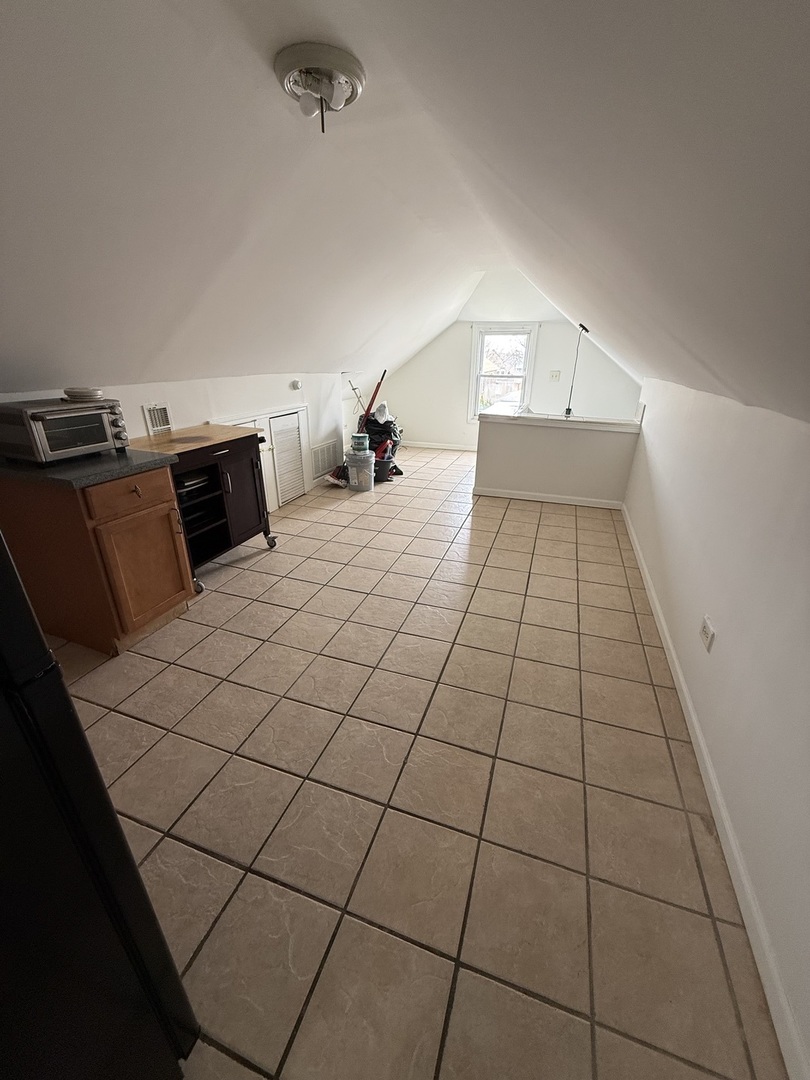 4612 South Spaulding Avenue, Unit 3 Chicago, IL 60632 - Photo 4 of 6 a room with a bed and a mirror