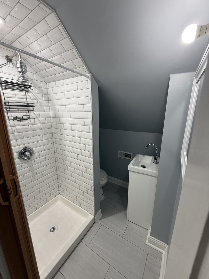 4612 South Spaulding Avenue, Unit 3 Chicago, IL 60632 - Photo 6 of 6 a bathroom with a shower and toilet