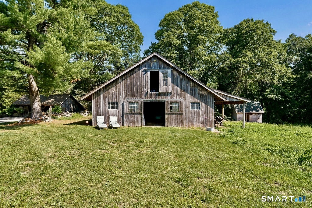 261-1 Grassy Hill Road Lyme, CT 06371 - Photo 4 of 40 The barn provides ample space for horses, animals, hobbies, or workshop space, enhancing the property's gentleman-farm appeal.