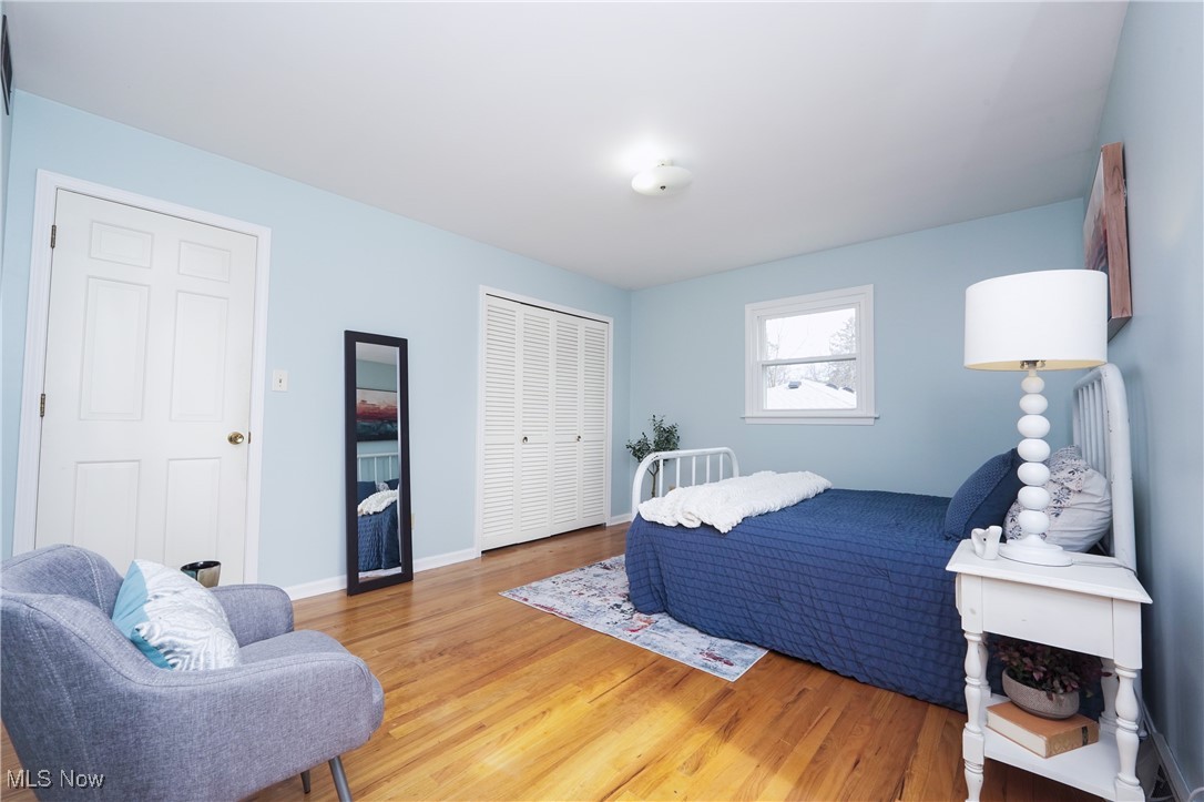2674 Smith Road Fairlawn, OH 44333 - Photo 17 of 31 Bedroom featuring a closet, baseboards, and light wood finished floors