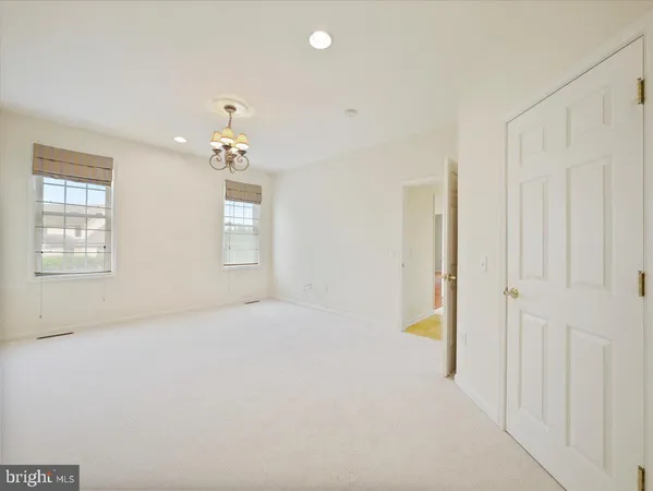 a view of an empty room with a window and fireplace