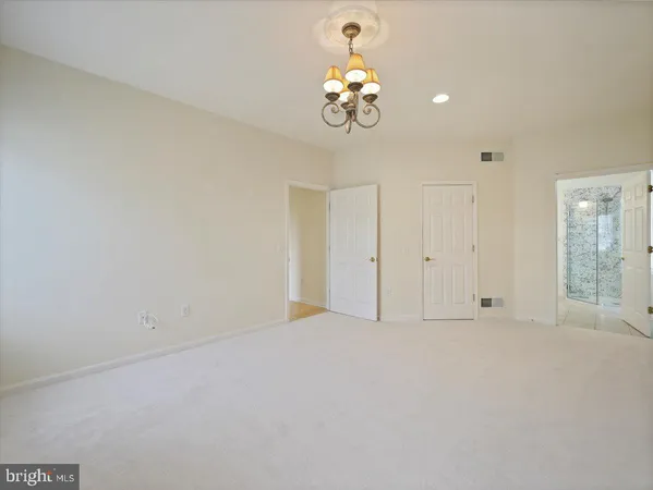 a view of empty room with wooden floor and fireplace