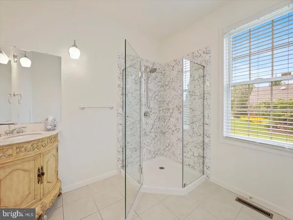 a view of empty room with wooden floor and fireplace