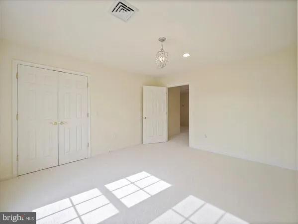a spacious bathroom with a tub shower and windows