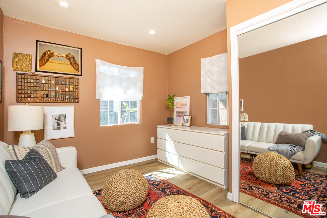 1663 South Rimpau Boulevard Los Angeles, CA 90019 - Photo 16 of 21 a bedroom with furniture and a large window