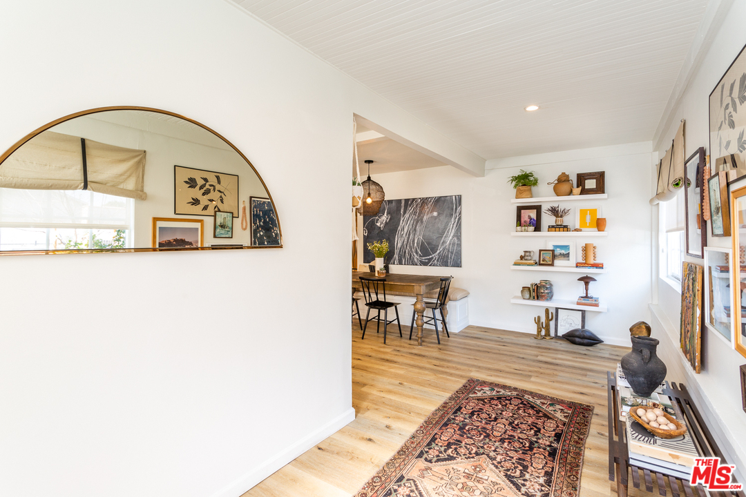 1663 South Rimpau Boulevard Los Angeles, CA 90019 - Photo 3 of 21 a living room with furniture and wooden floor