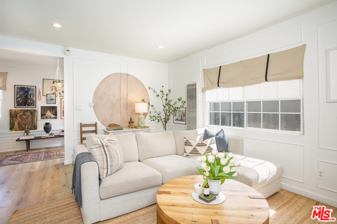 1663 South Rimpau Boulevard Los Angeles, CA 90019 - Photo 6 of 21 a living room with furniture and a large window