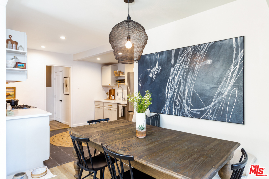 1663 South Rimpau Boulevard Los Angeles, CA 90019 - Photo 8 of 21 a view of a dining room with furniture and wooden floor