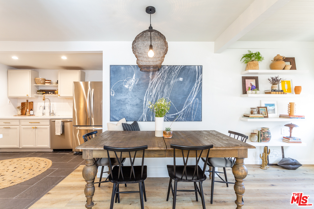 1663 South Rimpau Boulevard Los Angeles, CA 90019 - Photo 9 of 21 a view of a dining room with furniture and wooden floor