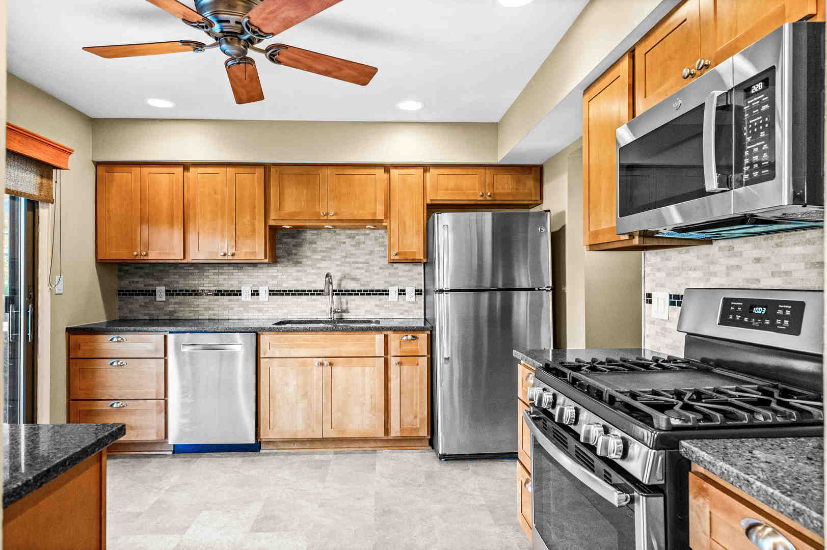 308 Raleigh Court Normal, IL 61761 - Photo 15 of 40 a kitchen with stainless steel appliances granite countertop a refrigerator a stove and a sink